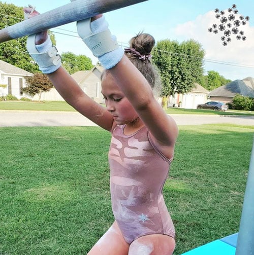 Gymnast in a blush pink gymnastics leotard