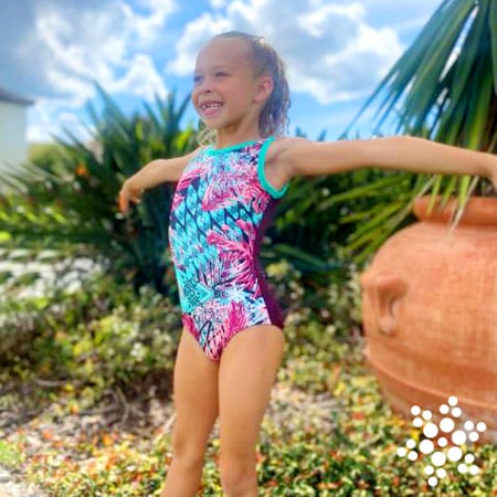 Blue and pink gymnastics leotard on a gymnast.