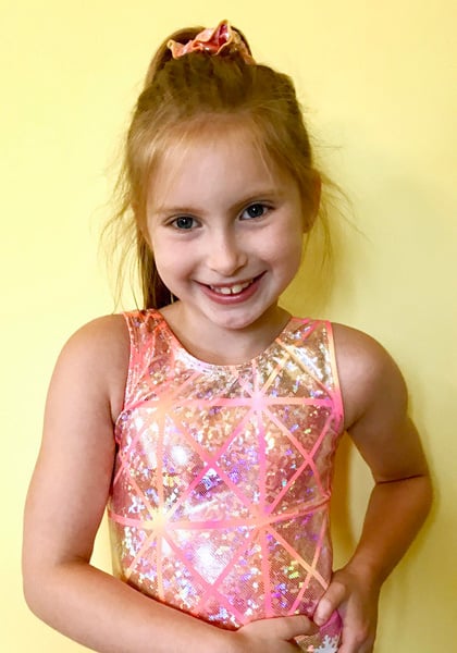 Gymnast in pink Snowflake leotard.
