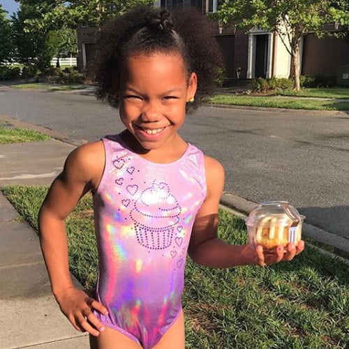 Gymnast wearing purple cupcake leotard from Snowflake Designs.