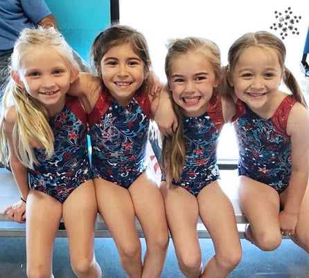 Four gymnasts in red, white and blue leotards.