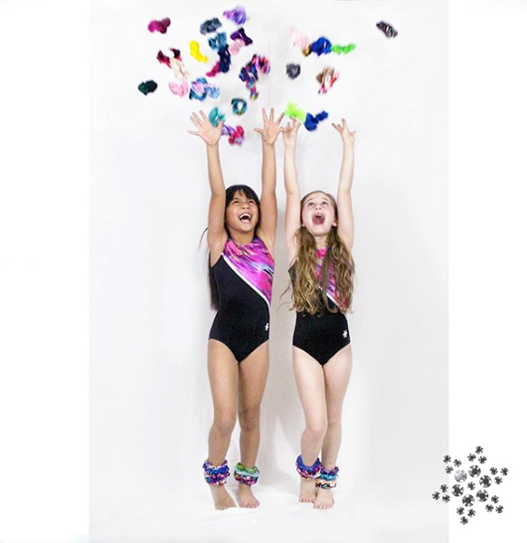 Gymnasts throwing hair scrunchies in Snowflake leotards