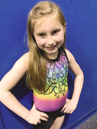 Ambassador in a colorful gymnastics leotard.