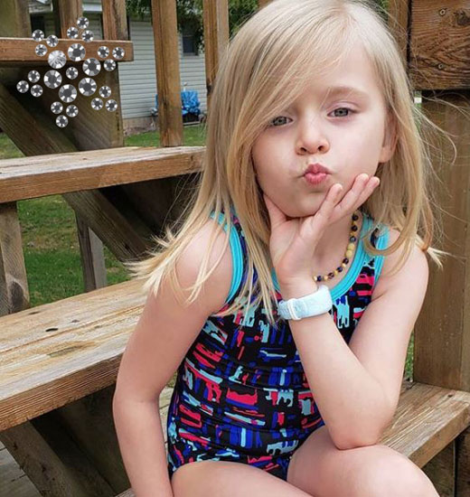 A gymnast in a black gymnastics leotard.