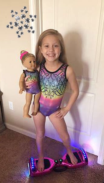 Gymnast and doll in matching gymnastic leotards.