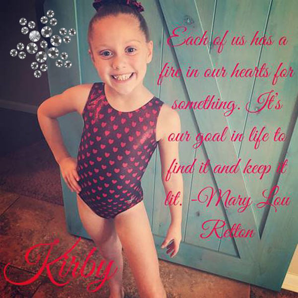 Kirby in a pink and black gymnastics leotard.